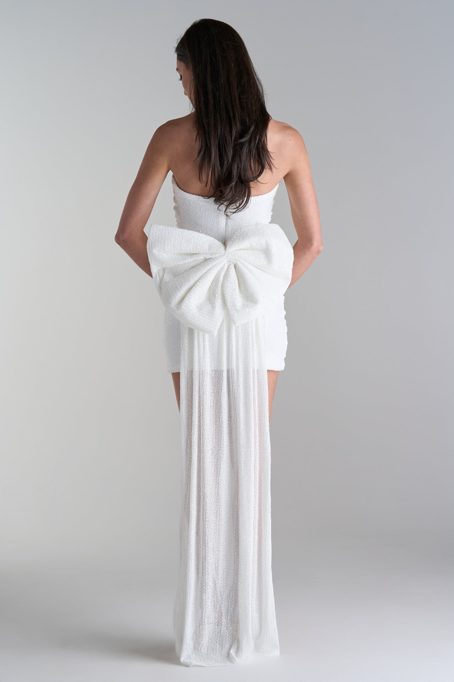 Model wearing mini dress with big bow