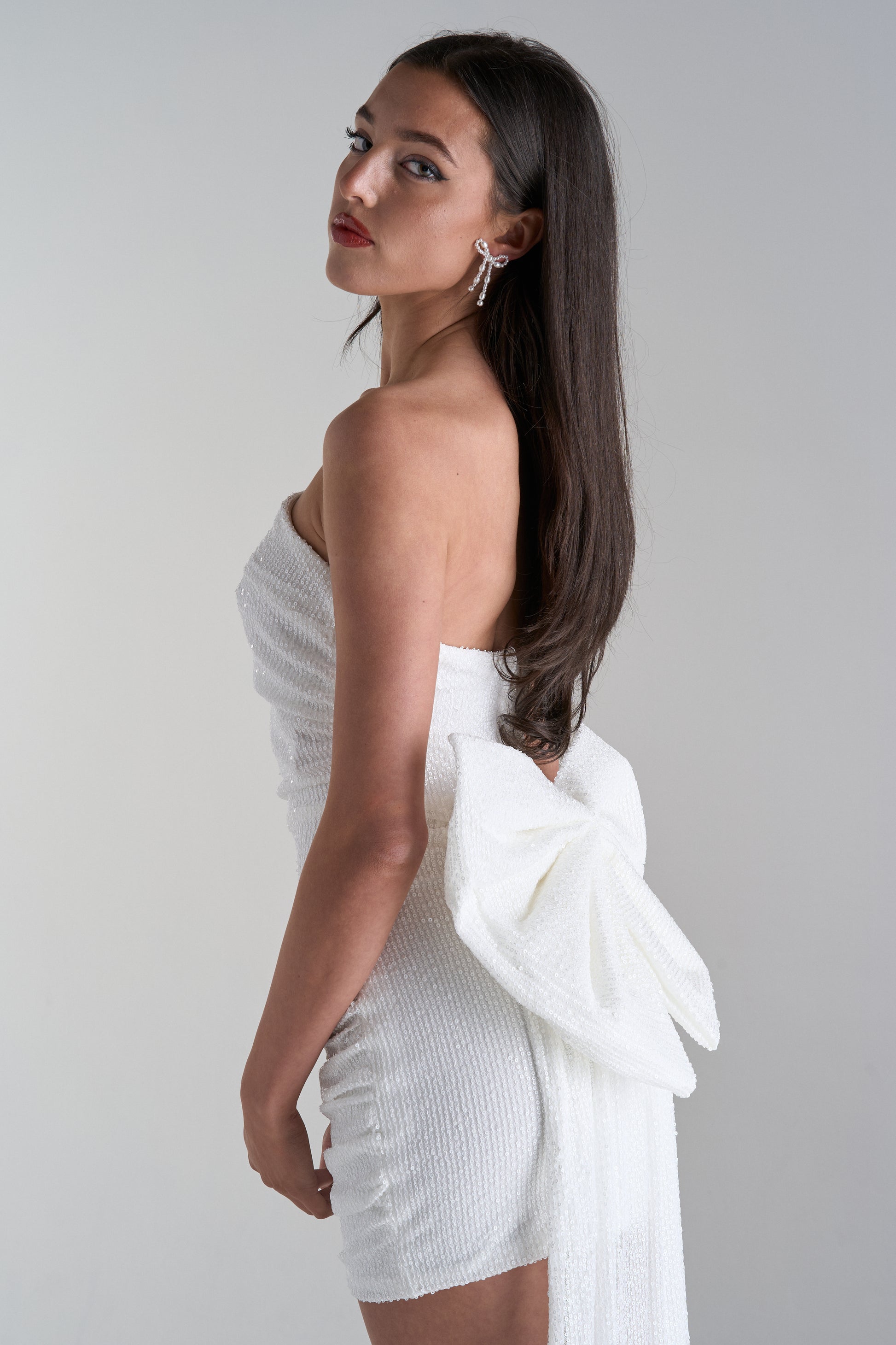 Model wearing mini dress with big bow