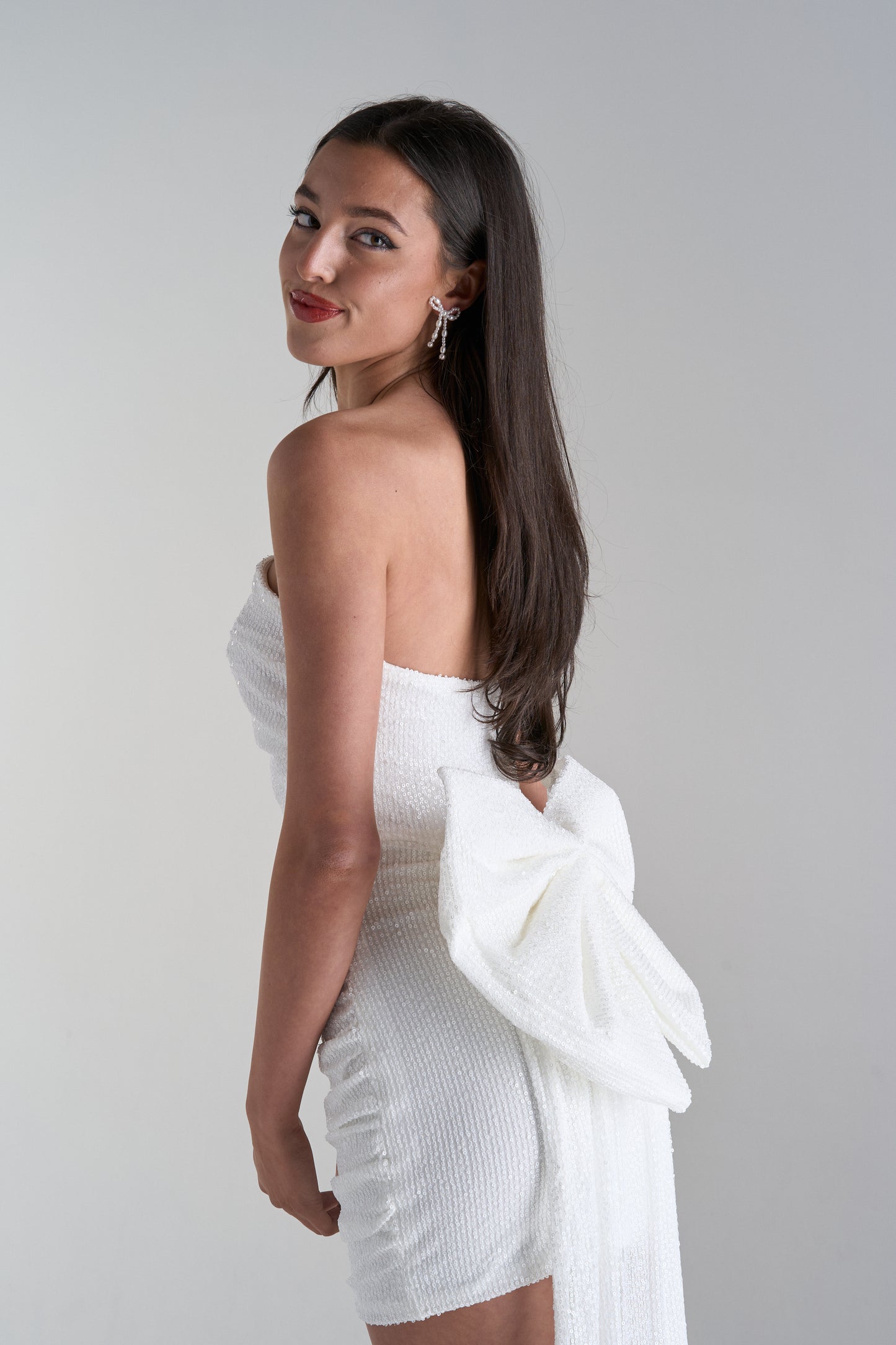 Model wearing mini dress with big bow