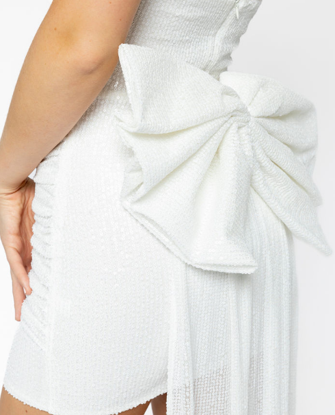 Model wearing mini dress with big bow