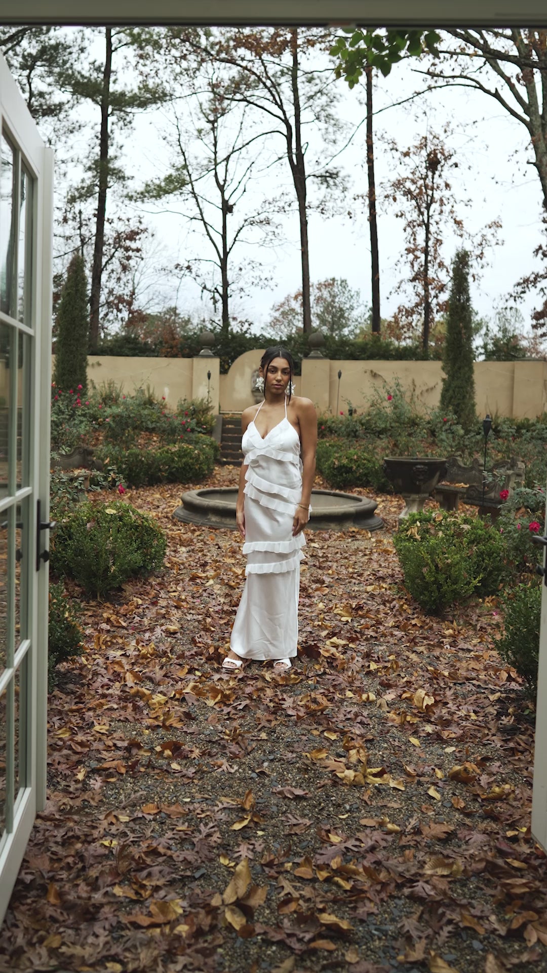 Video of Model in Ruffled White Gown out in a Garden 